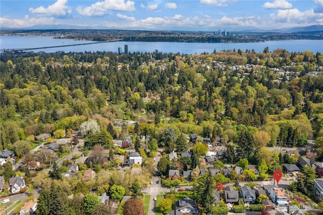 birds eye view of property with a water view and a residential view