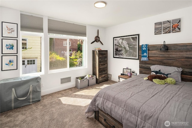 bedroom with baseboards, visible vents, and carpet floors