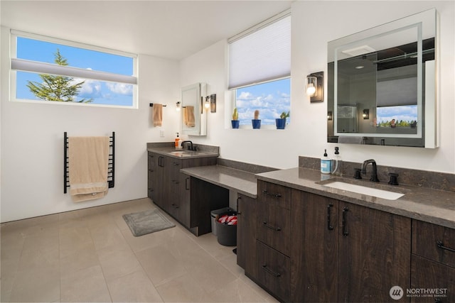 full bathroom with two vanities and a sink