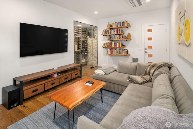 living room featuring wood finished floors, visible vents, and recessed lighting