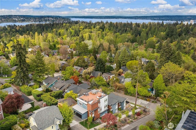 birds eye view of property featuring a water view, a forest view, and a residential view