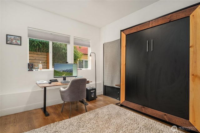 office space with wood finished floors and baseboards