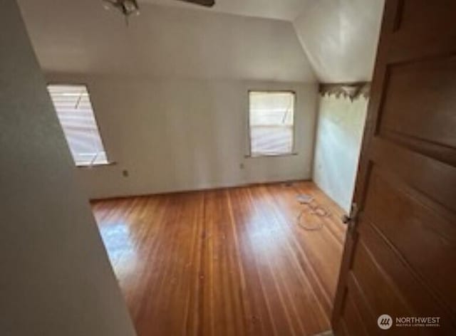 bonus room featuring wood finished floors, ceiling fan, and vaulted ceiling