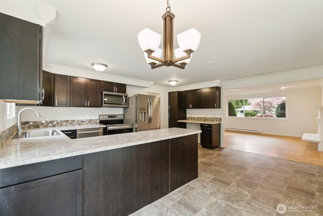 kitchen featuring an inviting chandelier, a sink, dark brown cabinetry, and stainless steel appliances