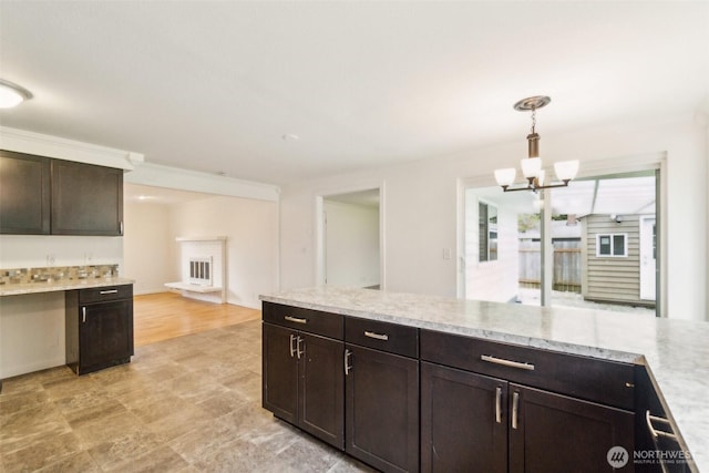 kitchen featuring dark brown cabinets, decorative light fixtures, and an inviting chandelier