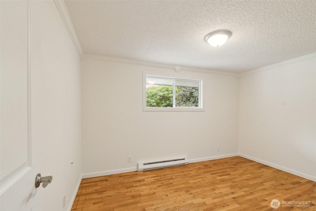empty room with crown molding, a textured ceiling, baseboard heating, and light wood-type flooring