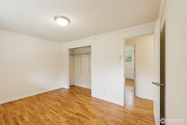 unfurnished bedroom with crown molding, a baseboard radiator, a textured ceiling, and light wood-style floors