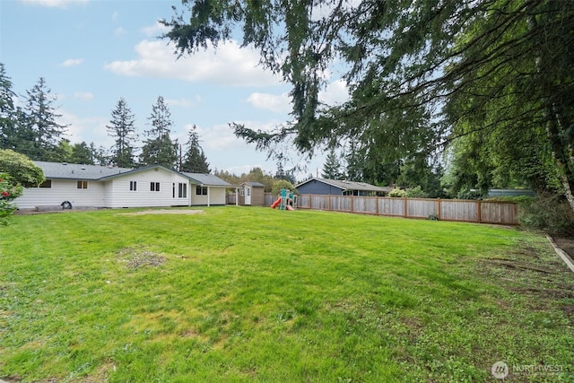 view of yard with a playground and fence