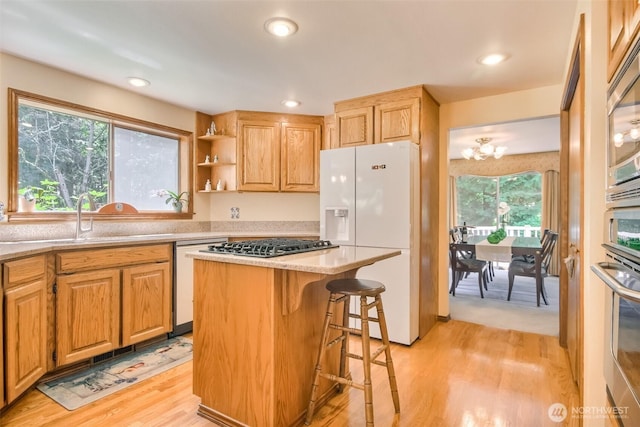 209 SW 331st Pl, Federal Way, WA 98023 - kitchen featuring white appliances, light wood-style flooring, a chandelier, a breakfast bar, and a center island