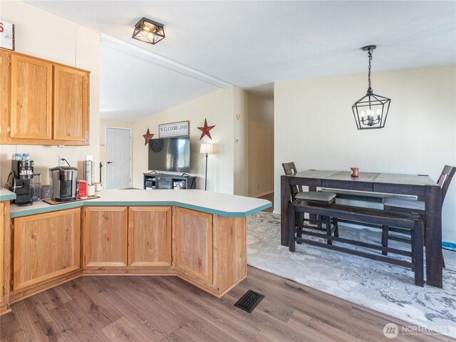 105 3rd St SW, Rock Island, WA 98850 - kitchen featuring visible vents, light countertops, a peninsula, dark wood-style floors, and a chandelier