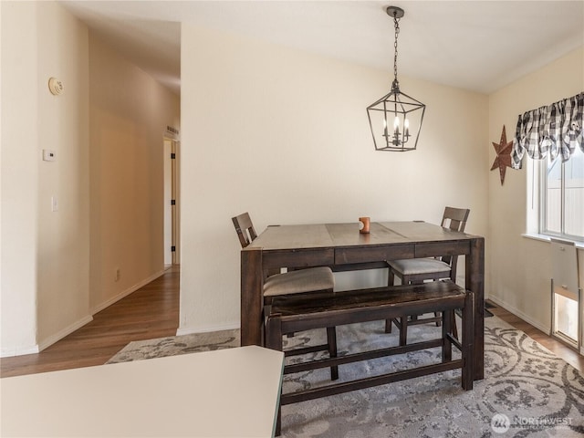 105 3rd St SW, Rock Island, WA 98850 - dining area with an inviting chandelier, baseboards, and wood finished floors