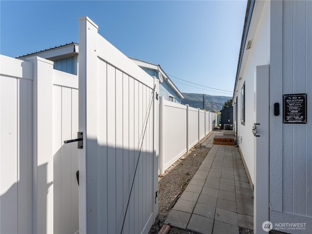 105 3rd St SW, Rock Island, WA 98850 - view of side of home with board and batten siding, fence, and a mountain view