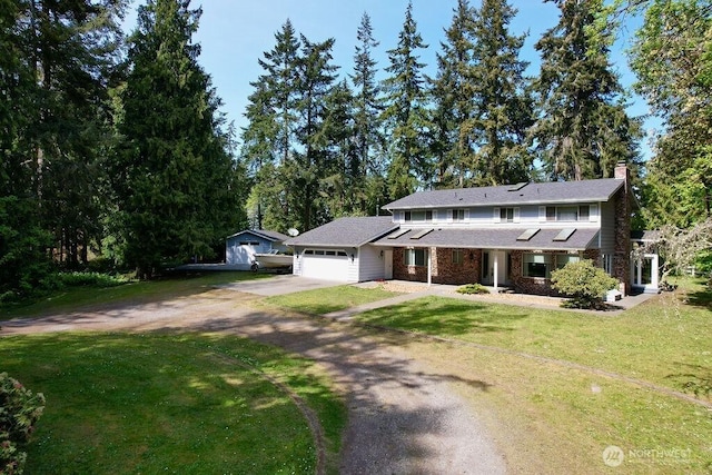 70 Shadow Trl, Sequim, WA 98382 - view of front of property featuring concrete driveway, a chimney, a front lawn, and an attached garage