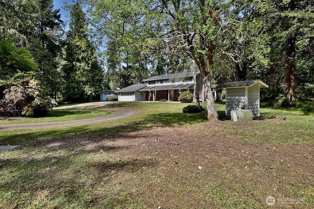 70 Shadow Trl, Sequim, WA 98382 - view of yard with dirt driveway and a garage