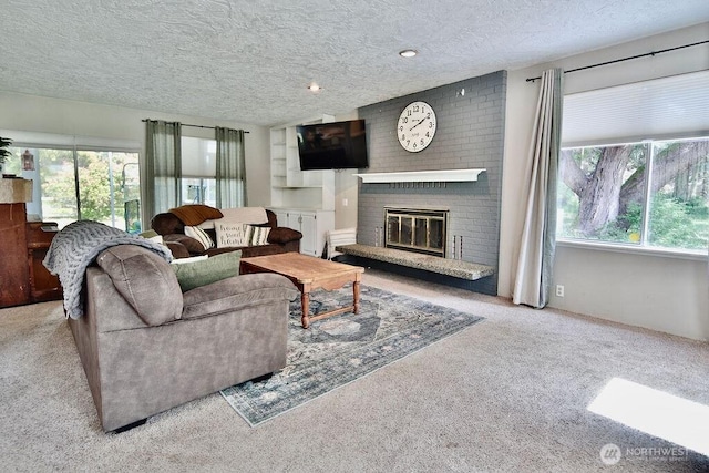 70 Shadow Trl, Sequim, WA 98382 - carpeted living area featuring a textured ceiling and a fireplace