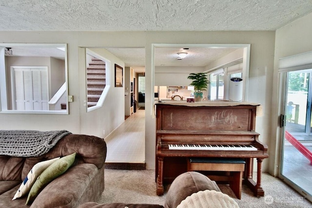 70 Shadow Trl, Sequim, WA 98382 - living area with a textured ceiling, stairs, a healthy amount of sunlight, and carpet floors