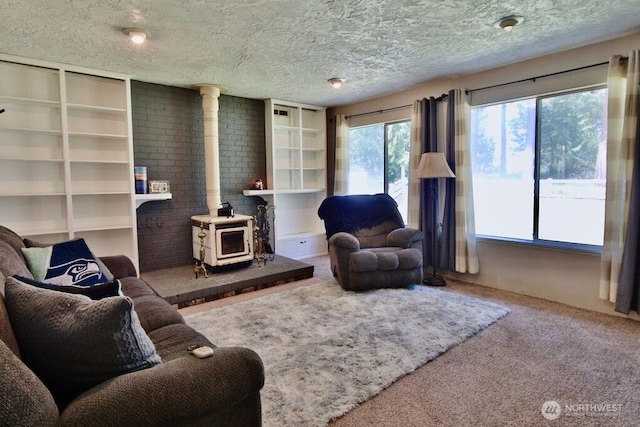 70 Shadow Trl, Sequim, WA 98382 - carpeted living room with a wood stove and a textured ceiling
