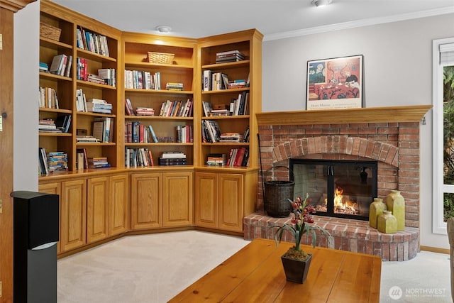 sitting room with light colored carpet, crown molding, and a fireplace