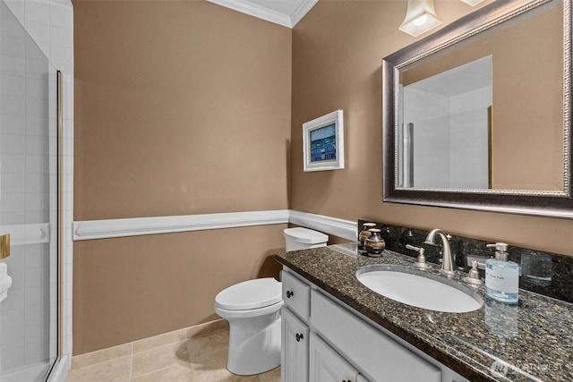 bathroom with crown molding, a tile shower, vanity, toilet, and tile patterned floors