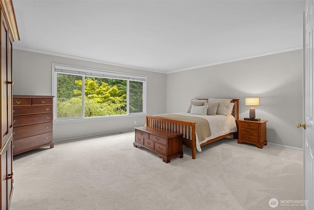 carpeted bedroom featuring crown molding and baseboards