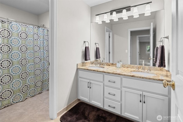 full bathroom featuring double vanity, a shower with curtain, a sink, and tile patterned flooring