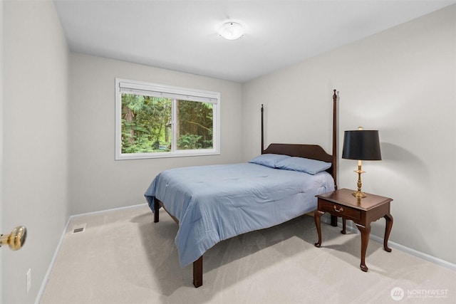 carpeted bedroom featuring baseboards and visible vents