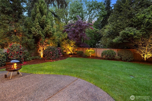 view of yard featuring fence and a patio