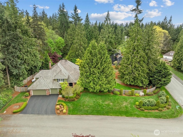 bird's eye view with a wooded view