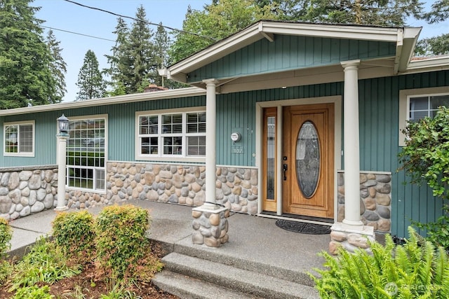1302 Spruce St, Longview, WA 98632 - doorway to property featuring stone siding and a porch