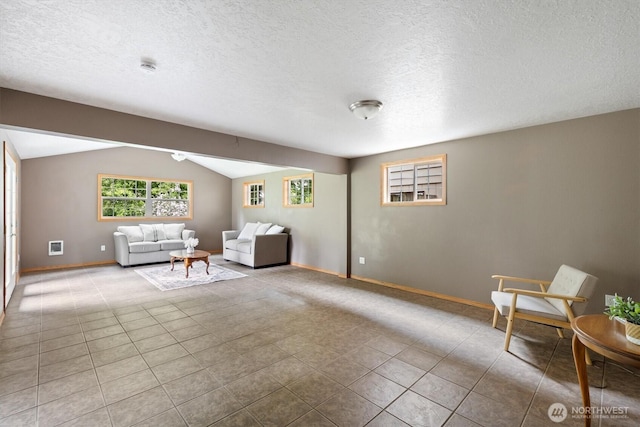1302 Spruce St, Longview, WA 98632 - sitting room featuring lofted ceiling, baseboards, a textured ceiling, and tile patterned floors