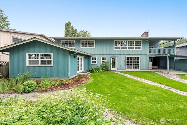 1302 Spruce St, Longview, WA 98632 - view of front of house featuring french doors, a front lawn, a chimney, a patio area, and a balcony