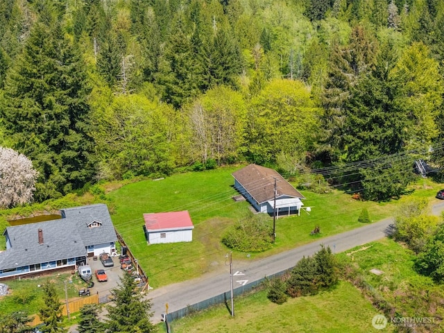 drone / aerial view with a wooded view