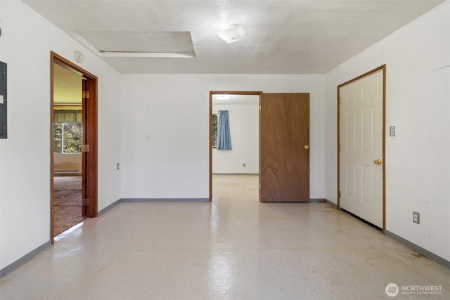 spare room with baseboards