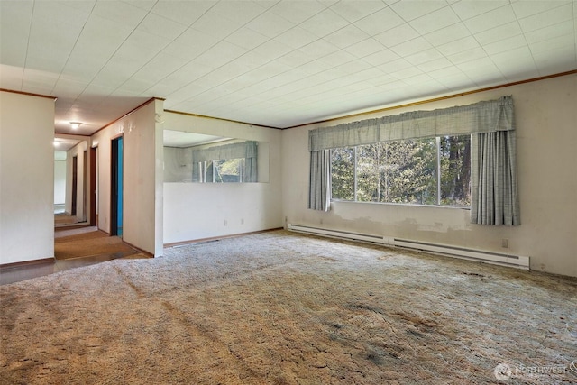 empty room featuring a baseboard heating unit, ornamental molding, and carpet