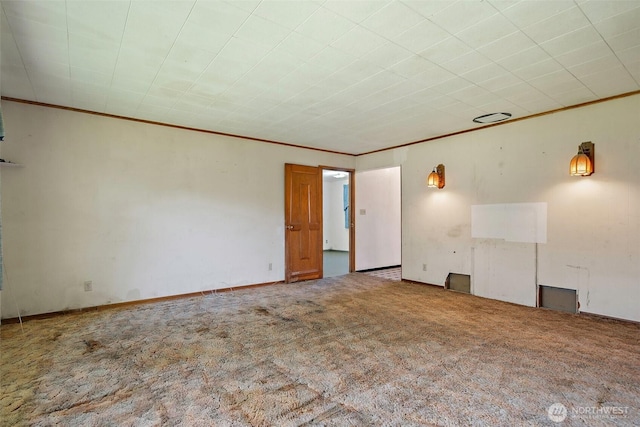 carpeted spare room with crown molding