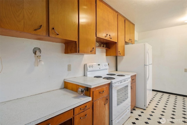kitchen with light floors, white appliances, light countertops, and brown cabinetry