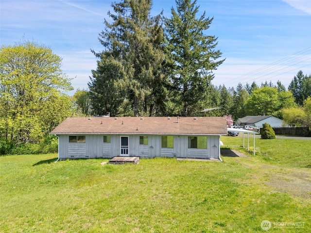 rear view of property featuring a yard