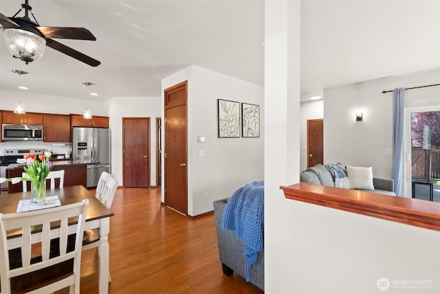 interior space featuring recessed lighting, a ceiling fan, wood finished floors, and baseboards