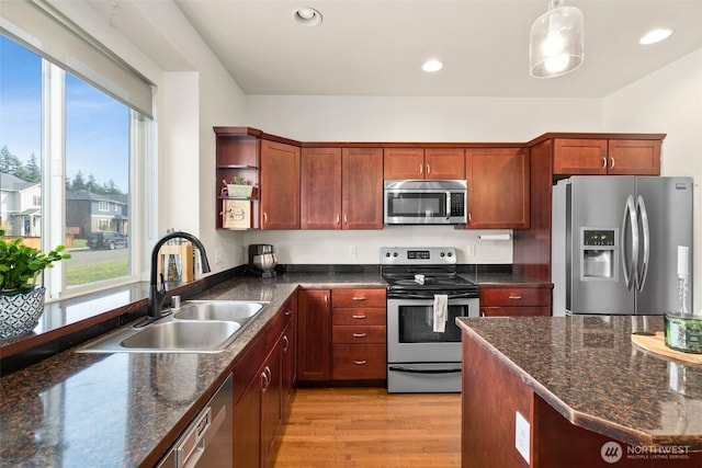 kitchen featuring open shelves, plenty of natural light, appliances with stainless steel finishes, and a sink