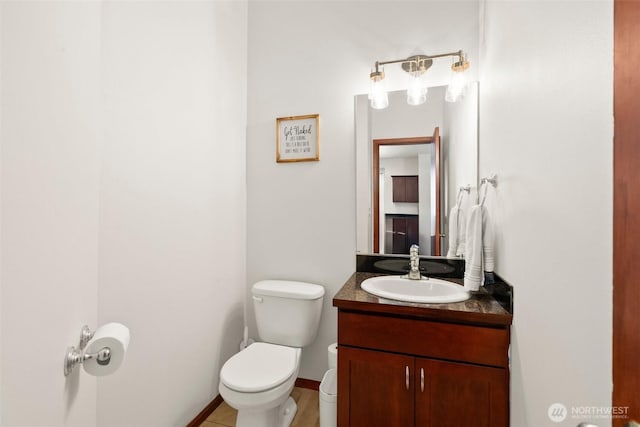 half bath featuring toilet and vanity