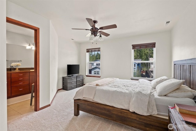 bedroom featuring visible vents, light carpet, a ceiling fan, and multiple windows