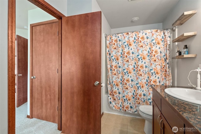 full bathroom featuring vanity, toilet, tile patterned flooring, and shower / tub combo with curtain