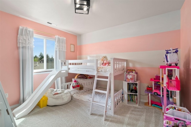carpeted bedroom with baseboards and visible vents