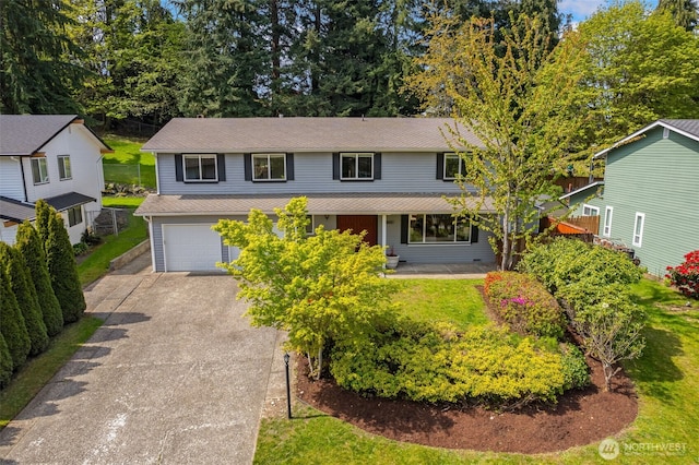 traditional-style house featuring an attached garage, roof with shingles, and driveway