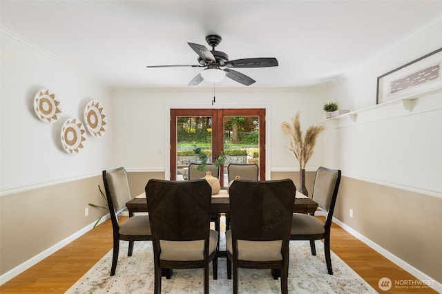 dining space with crown molding, ceiling fan, baseboards, and light wood-style floors