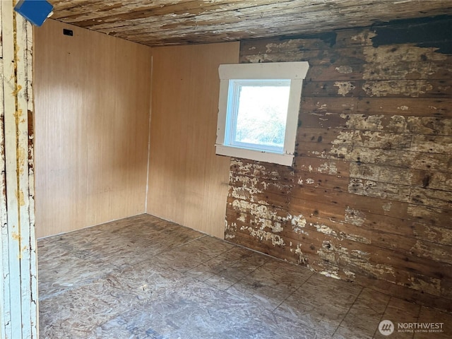 empty room with wood walls and wooden ceiling
