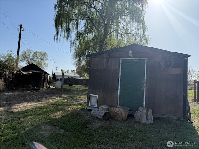 view of shed featuring fence