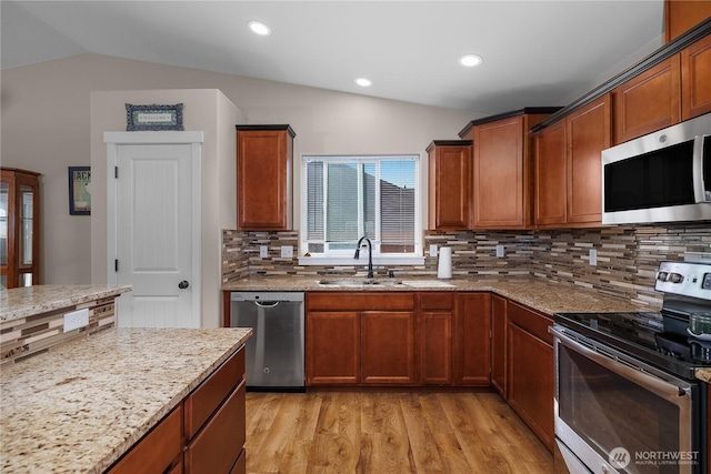 9321 179th Ln SW, Rochester, WA 98579 - kitchen featuring stainless steel appliances, a sink, lofted ceiling, light wood-type flooring, and tasteful backsplash