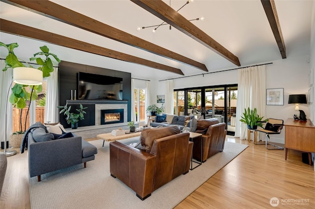909 11th St, Mukilteo, WA 98275 - living room with beamed ceiling, a wealth of natural light, light wood finished floors, and a glass covered fireplace