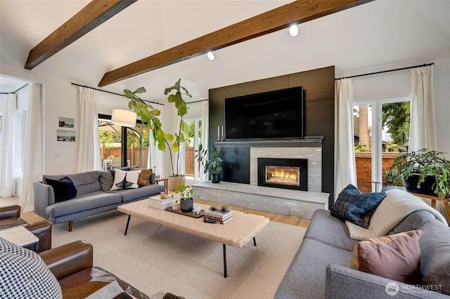 909 11th St, Mukilteo, WA 98275 - living room with lofted ceiling with beams, wood finished floors, and a glass covered fireplace